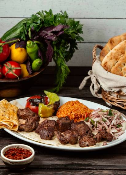 meat bulgur and onion with sumac on a wooden table